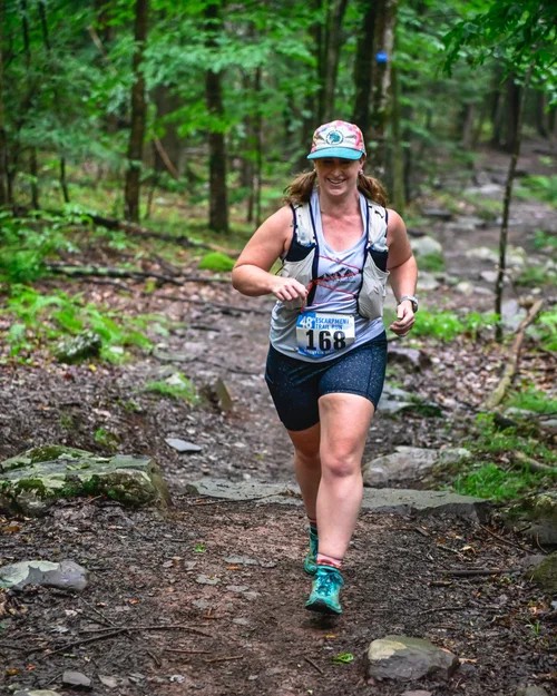 A trail runner on a rocky stretch of the course
